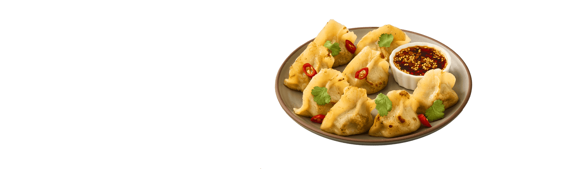 Dumplings on a plate with a small bowl of dipping sauce on a transparent background